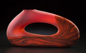Trans Bolinas shown in red color by Bernard Katz Trans Bolinas shown in red color is a hand blown glass sculpture created by Bernard Katz
