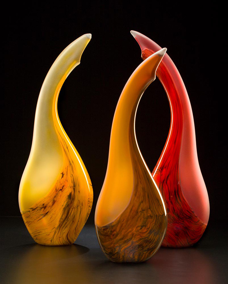 Salinas 3 color group glass sculpture showing yellow, cinnamon, and red versions by Bernard Katz