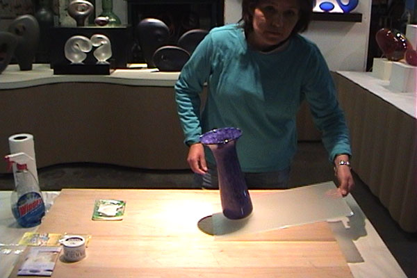 Katie Katz securing glass vase with poster putty