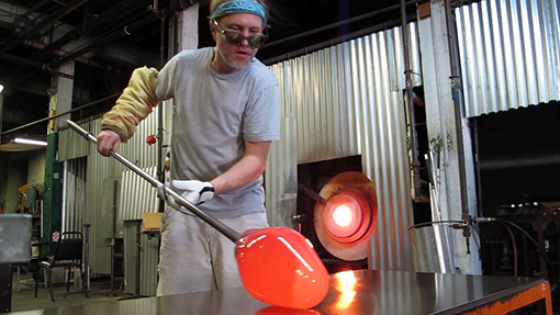 Glass Blowing - marving a hot glass sculpture